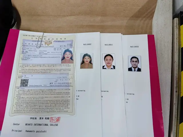 Certificates of Eligibility laid out beside participants' ID photos