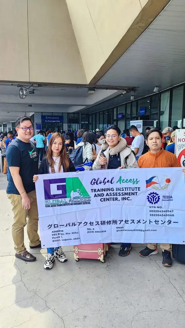 Group holding the GLOBAL ACCESS banner in an airport hall