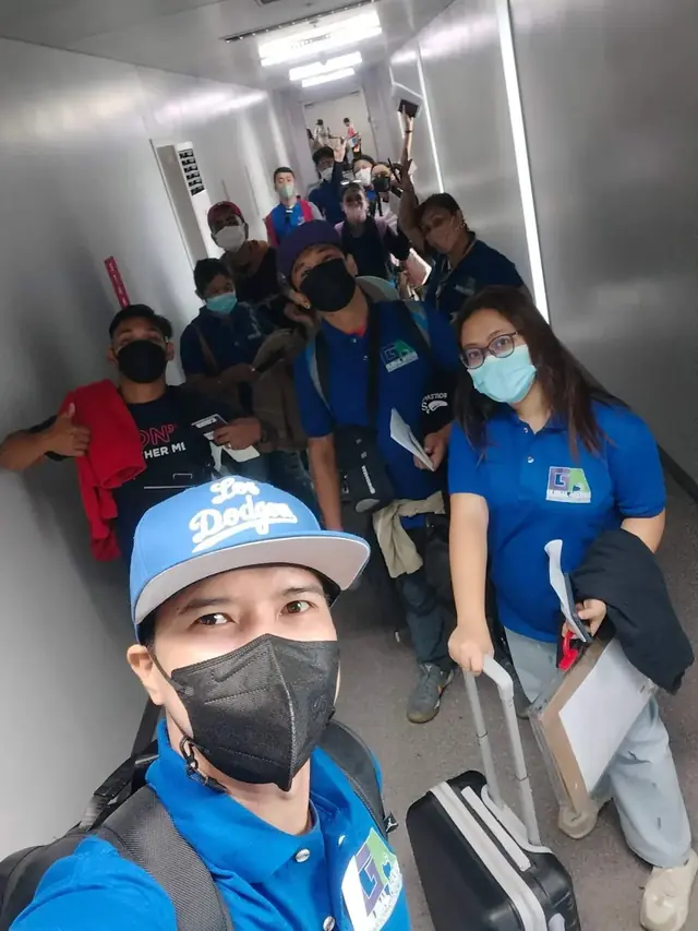 Group of participants walking down a corridor toward their gate
