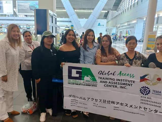 Group of women gathered around the GLOBAL ACCESS banner in the terminal