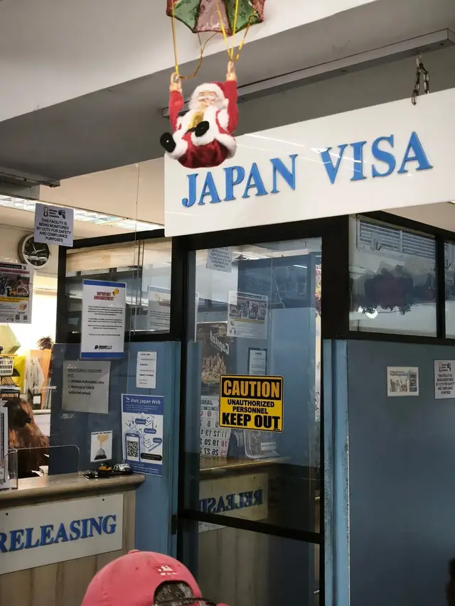 Japan visa application office entrance with a holiday decoration above the door
