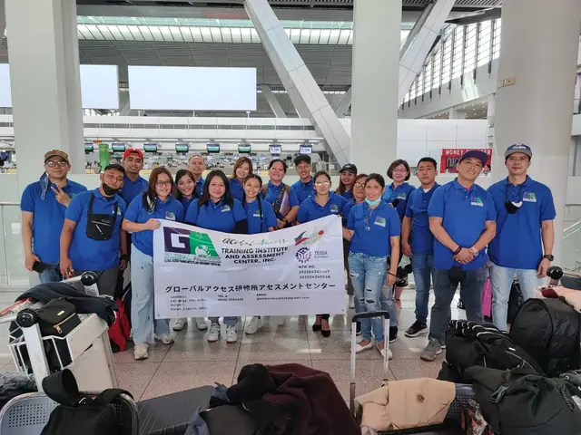 Large group in blue shirts with the GLOBAL ACCESS banner in the departure hall