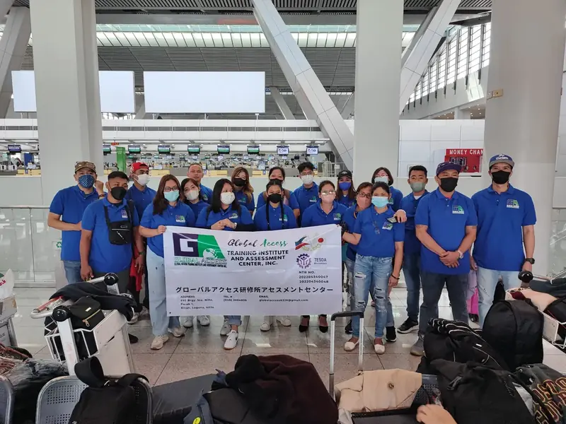 Large group with the GLOBAL ACCESS banner in front of the check-in counters