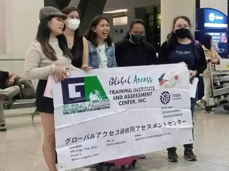 Participants laughing while holding the GLOBAL ACCESS banner