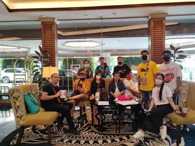 Participants resting together in an airport hotel lobby before the flight