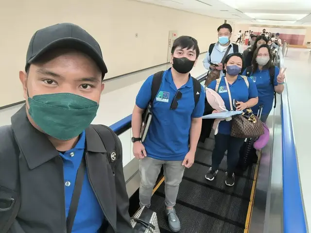 Participants riding a moving walkway with a selfie in the foreground