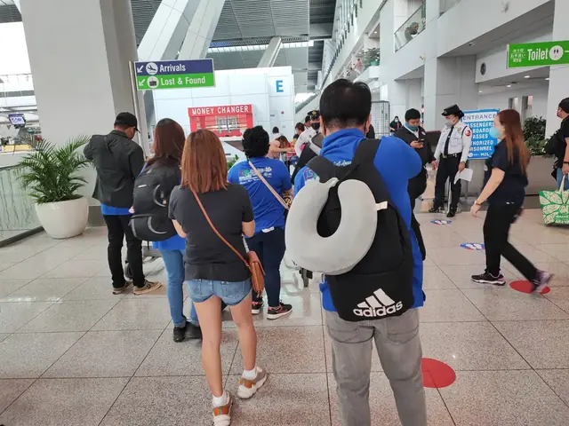 Participants walking through the airport arrivals hall