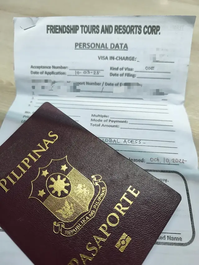 Passport lying on a visa application personal data form