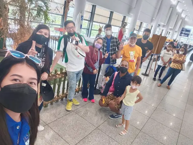 Selfie with a group of travelers and a child in the airport terminal