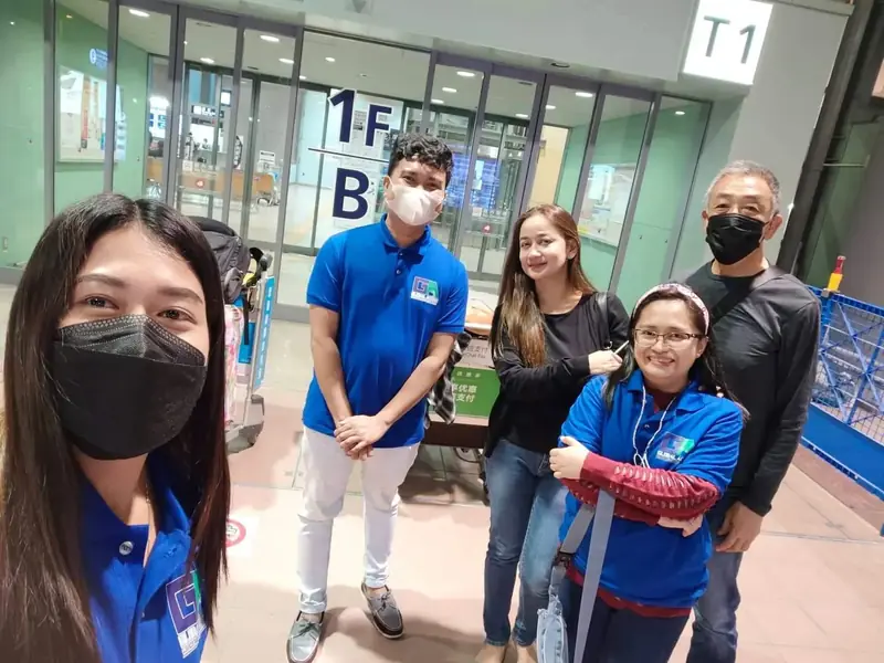 Selfie at the Terminal 1 entrance with participants and staff