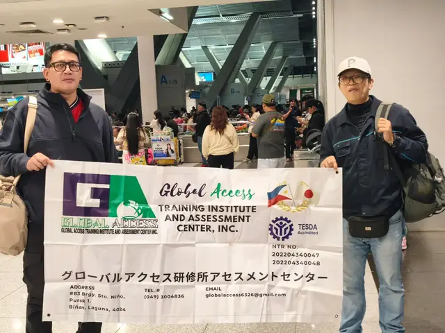 Two men holding the GLOBAL ACCESS banner in the airport terminal