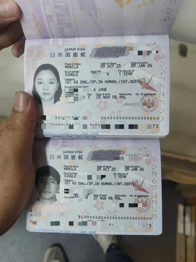 Two passports opened to Japan visa stickers